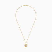 The Novelty 14K Yellow Gold Diamond Evil Eye Disk Pendant features a round design with white and black stones forming the eye, delicately hanging from a gold chain.