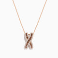 The 14K Rose Gold Brown and White Diamond Pendant features an “X”-shaped design with intertwined rows of brown and white diamonds, suspended from a delicate chain.