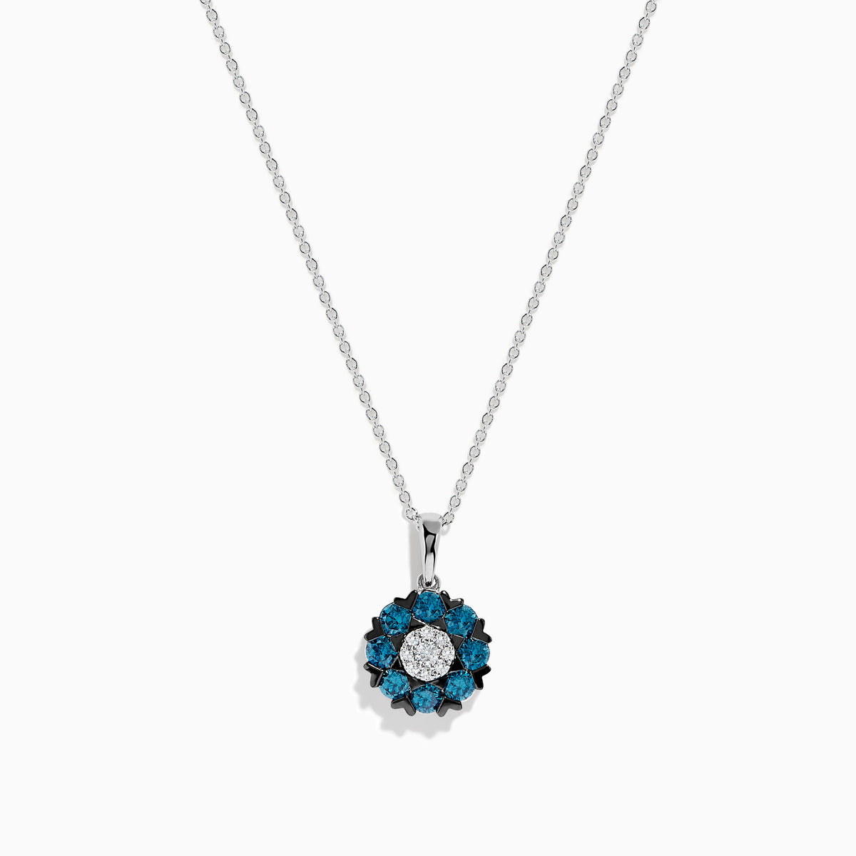 The Bella Bleu 14K White Gold Blue and White Diamond Flower Pendant features a circular floral design with a center cluster of white stones surrounded by sparkling blue and white diamonds.