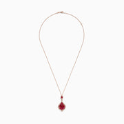 The Ruby Royale 14K Rose Gold Ruby and Diamond Pendant features red marquise-cut rubies in a floral design, bordered by sparkling diamonds, and hangs from a delicate rose gold chain.