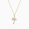 The 14K Yellow Gold Diamond Palm Tree Pendant features a delicate chain and sparkling white stones, combining gold and silver tones for an elegant, eye-catching look.