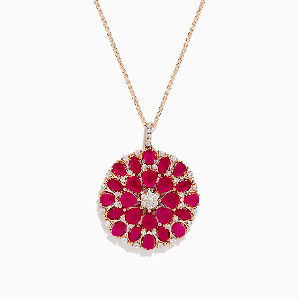 The Ruby Royale 14K Rose Gold Ruby and Diamond Flower Pendant features a round floral design with rubies and diamond accents at the center and edges.