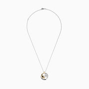 The Seaside 14K Two-Tone Gold Diamond Dolphin Pendant features a circular design with a gold dolphin, silver wave, sparkling diamonds, and hangs from a delicate silver chain displayed on a white background.