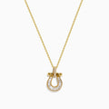 The DOro 14K Yellow Gold Diamond Horseshoe Pendant features a delicate yellow gold chain with a horseshoe pendant adorned with small, clear baguette-cut diamonds and elegant gold accents.