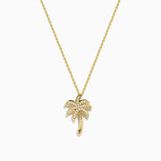 The 14K Yellow Gold Diamond Palm Tree Pendant features a delicate yellow gold chain and a palm tree pendant with a curved trunk, detailed fronds, and sparkling diamond accents.