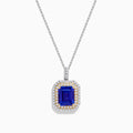 The Nahla 14K White & Yellow Gold Tanzanite and Diamond Pendant showcases a large emerald-cut blue tanzanite framed by a double halo of diamonds and yellow stones, elegantly hanging from a delicate chain.