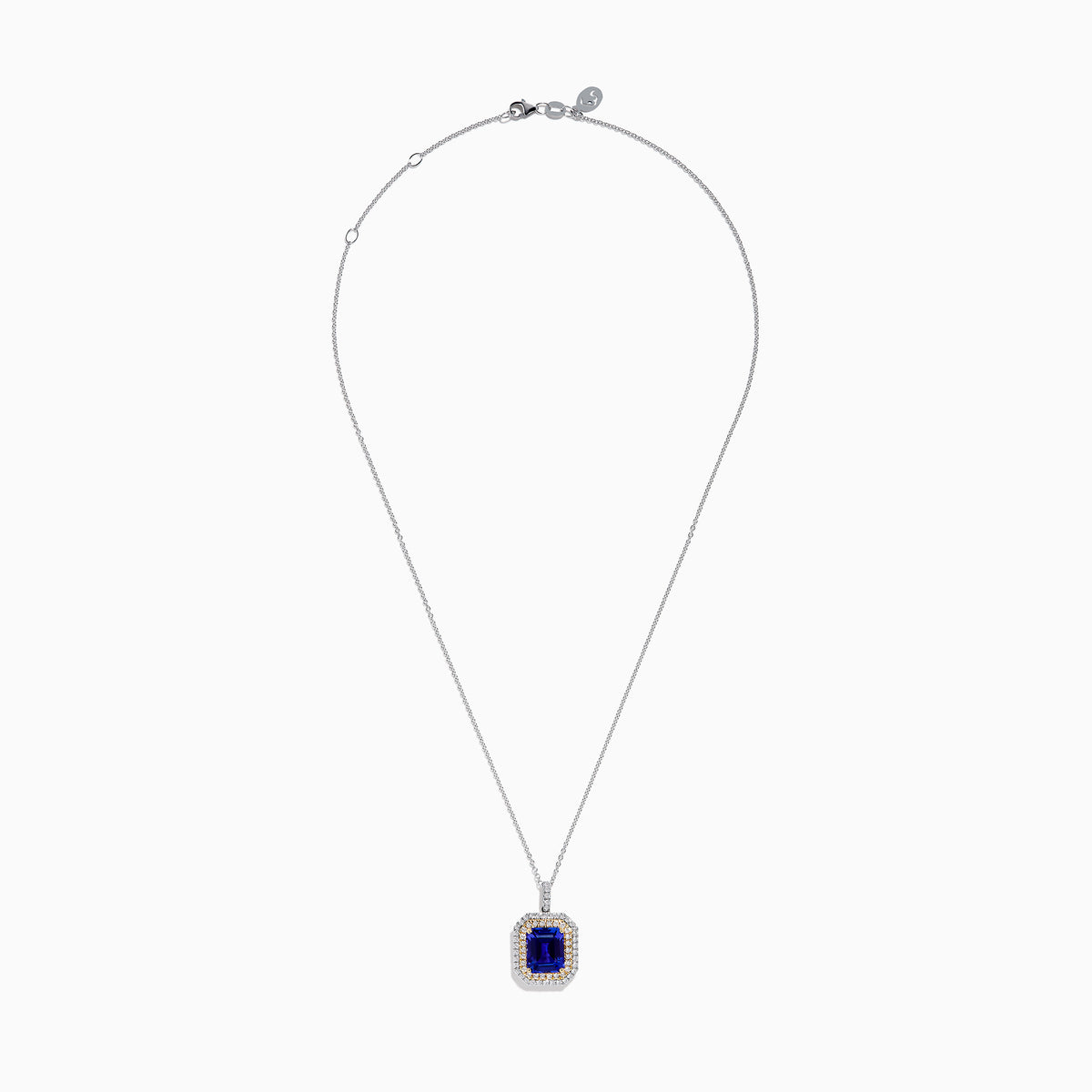 The Nahla 14K White & Yellow Gold Tanzanite and Diamond Pendant showcases a large emerald-cut blue tanzanite framed by a double halo of diamonds and yellow stones, elegantly hanging from a delicate chain.
