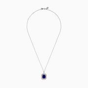 The Nahla 14K White & Yellow Gold Tanzanite and Diamond Pendant showcases a large emerald-cut blue tanzanite framed by a double halo of diamonds and yellow stones, elegantly hanging from a delicate chain.