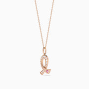 The Novelty 14K Rose Gold Pink Sapphire & Diamond Pink Ribbon Pendant features a diamond pink ribbon with clear gemstones and a single pink sapphire, displayed on a rose gold chain against a plain white background.
