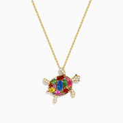 The Seaside 14K Yellow Gold Multi Sapphire and Diamond Turtle Pendant features sapphire gemstones on the shell and diamonds on the head and limbs, all hanging from a delicate gold chain.