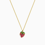 The Novelty 14K Yellow Gold Ruby and Tsavorite Strawberry Pendant features red rubies and green tsavorites on a chain necklace, capturing a strawberry’s shape and leafy top against a plain white background.