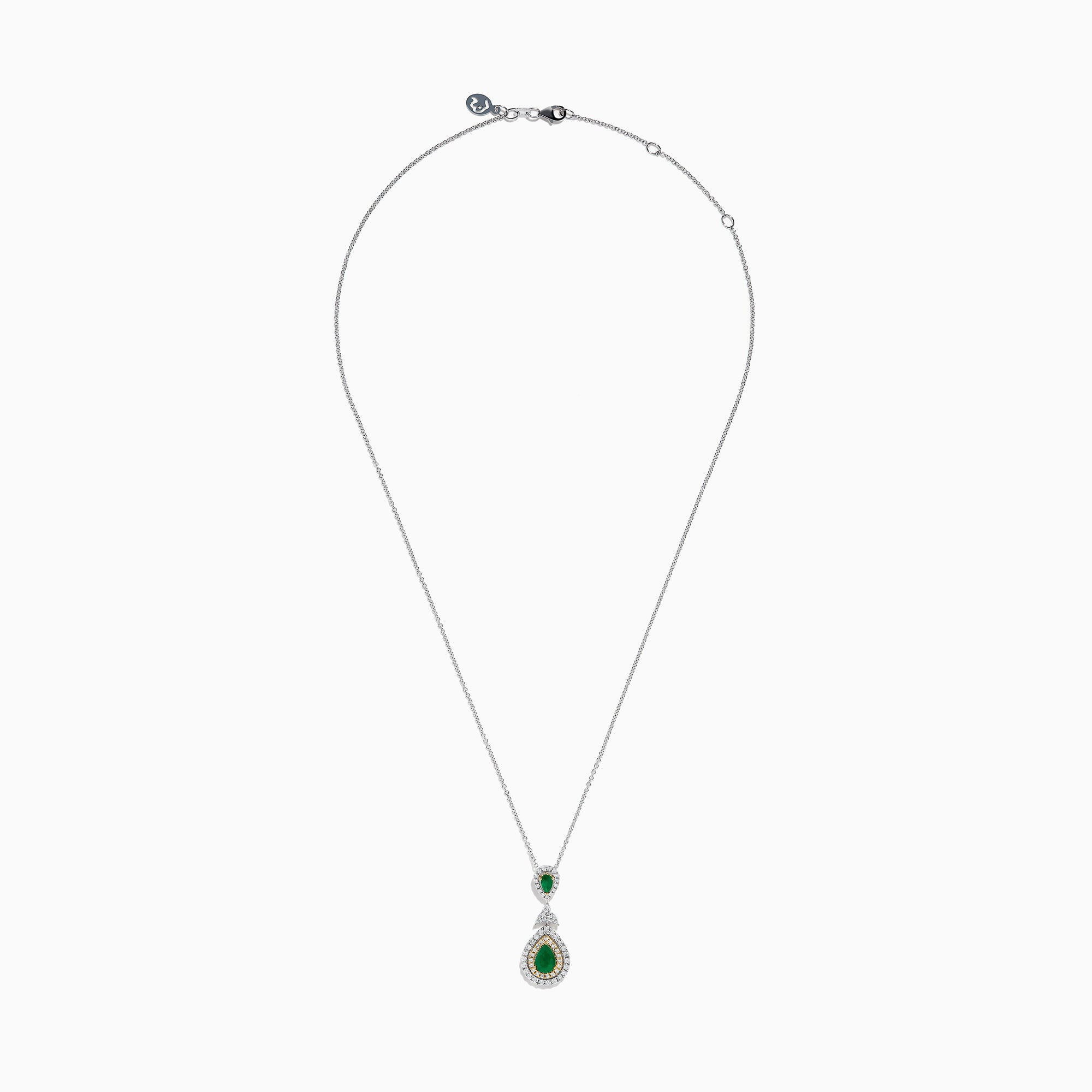The 14K Two Tone Gold Emerald and Diamond Double Pear Drop Pendant features two pear-shaped emeralds, each encircled by white diamonds and linked with a cluster of diamonds.