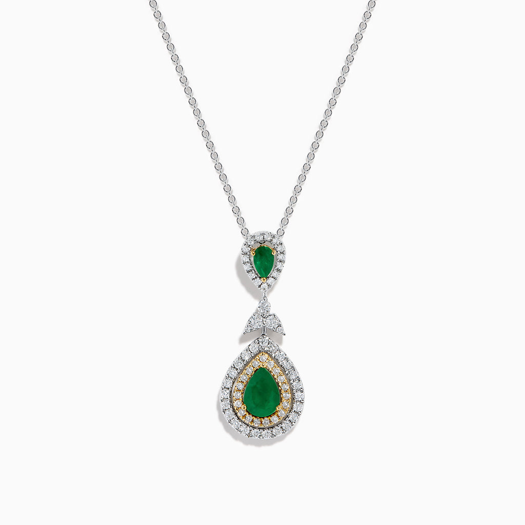 The 14K Two Tone Gold Emerald and Diamond Double Pear Drop Pendant features two pear-shaped emeralds, each encircled by white diamonds and linked with a cluster of diamonds.