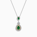 The 14K Two Tone Gold Emerald and Diamond Double Pear Drop Pendant features two pear-shaped emeralds, each encircled by white diamonds and linked with a cluster of diamonds.