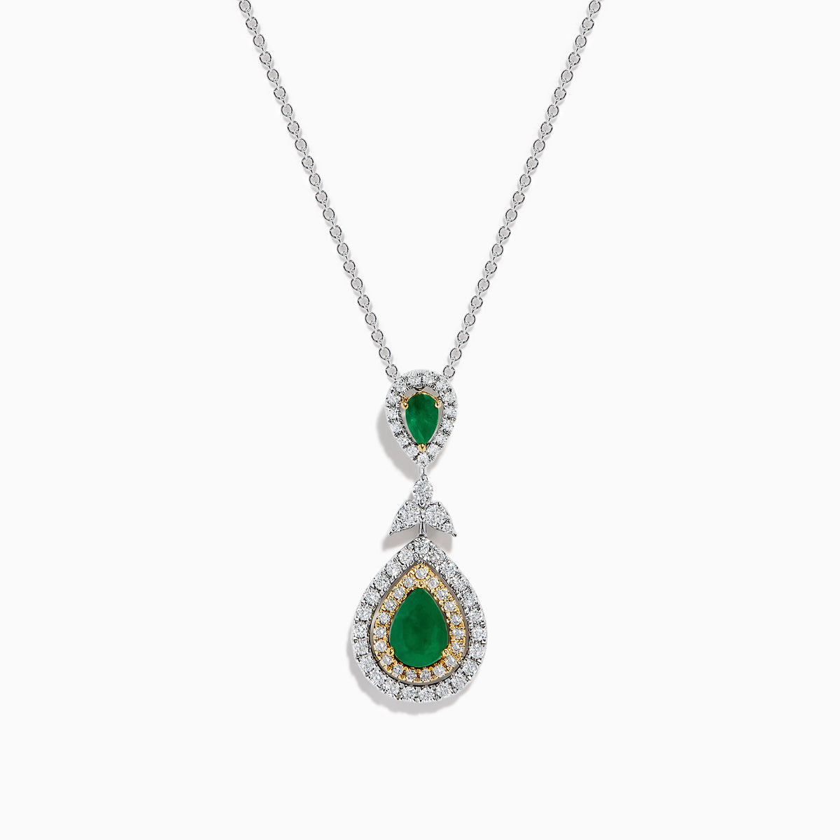 The 14K Two Tone Gold Emerald and Diamond Double Pear Drop Pendant features two pear-shaped emeralds, each encircled by white diamonds and linked with a cluster of diamonds.