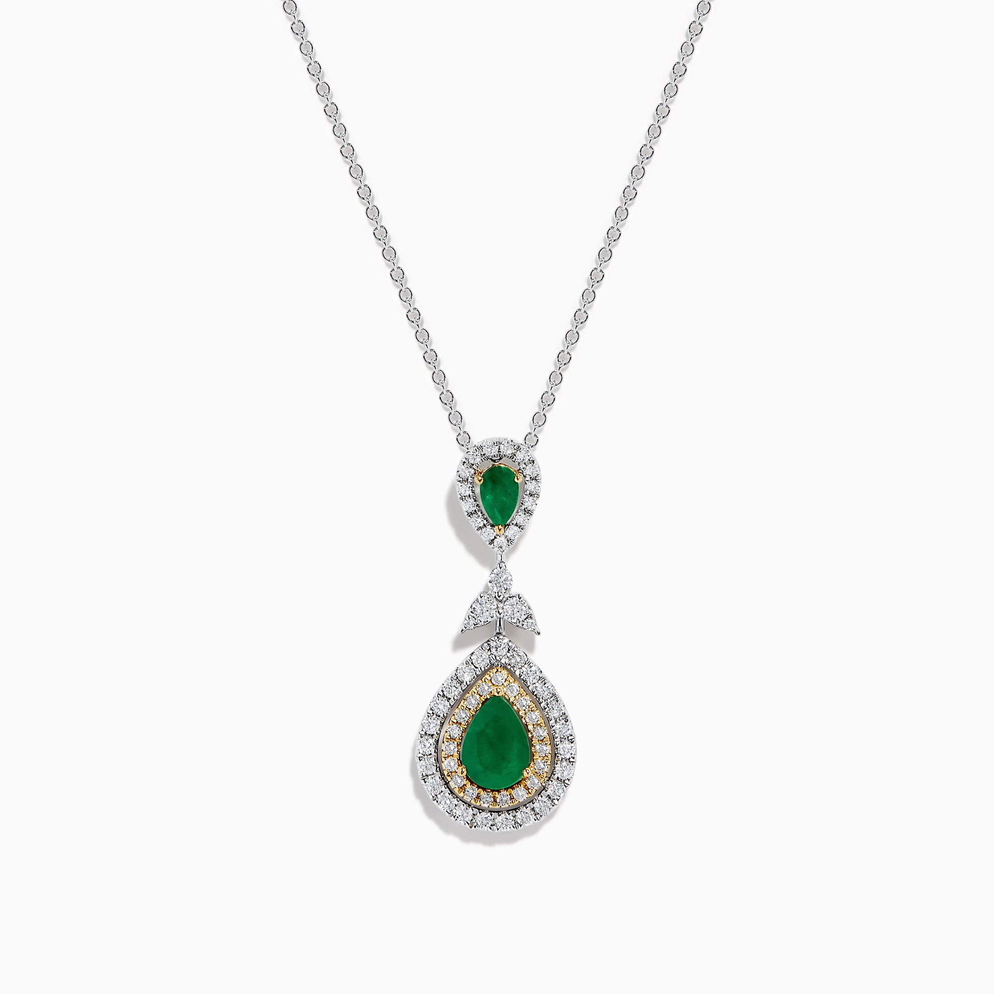 The 14K Two Tone Gold Emerald and Diamond Double Pear Drop Pendant features two pear-shaped emeralds, each encircled by white diamonds and linked with a cluster of diamonds.