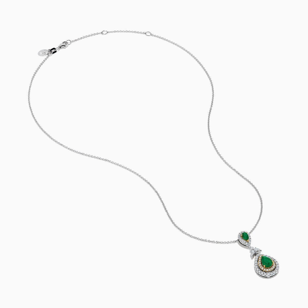 The 14K Two Tone Gold Emerald and Diamond Double Pear Drop Pendant features two pear-shaped emeralds, each encircled by white diamonds and linked with a cluster of diamonds.