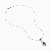 The 14K Two Tone Gold Emerald and Diamond Double Pear Drop Pendant features two pear-shaped emeralds, each encircled by white diamonds and linked with a cluster of diamonds.