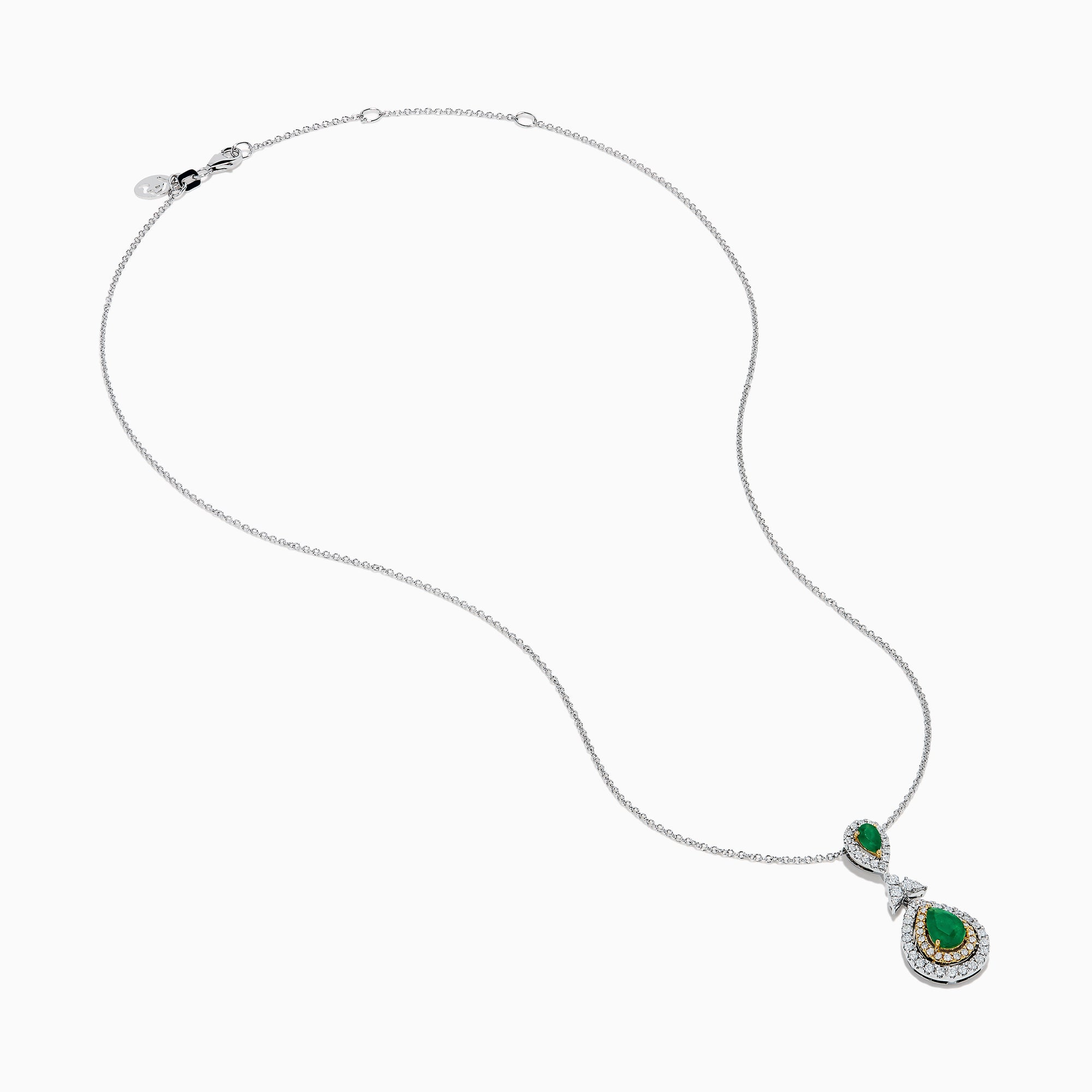 The 14K Two Tone Gold Emerald and Diamond Double Pear Drop Pendant features two pear-shaped emeralds, each encircled by white diamonds and linked with a cluster of diamonds.