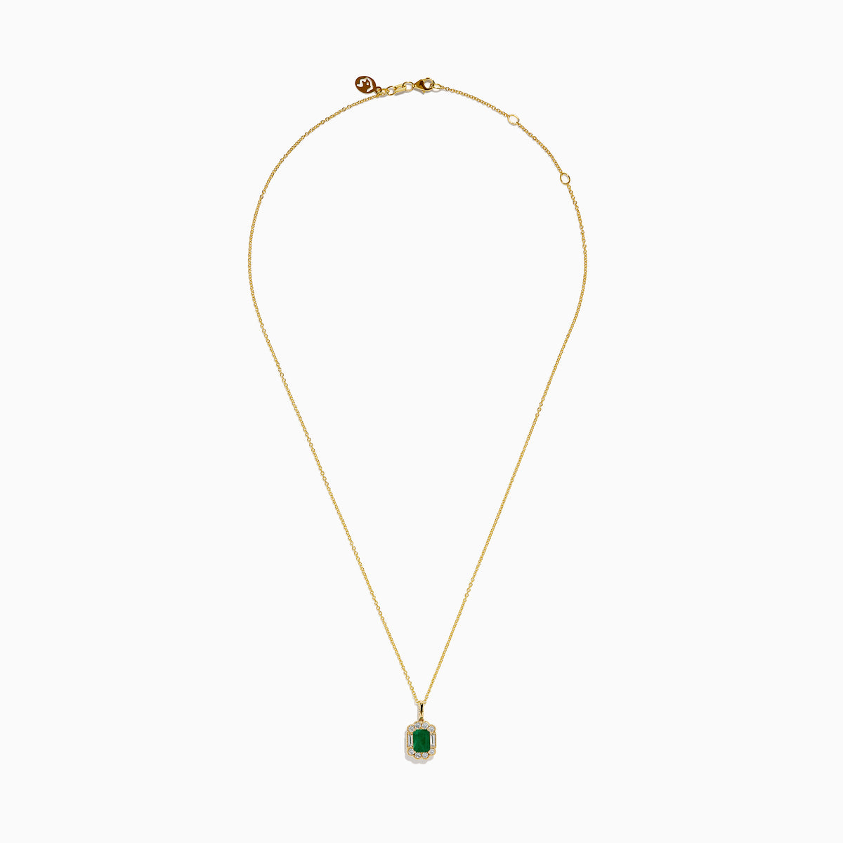 The 14K Yellow Gold Emerald and Diamond Halo Pendant features a rectangular green emerald, surrounded by round and baguette diamonds in a halo setting, all centrally suspended from a delicate gold chain.