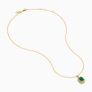 The 14K Yellow Gold Emerald and Diamond Halo Pendant features a rectangular green emerald, surrounded by round and baguette diamonds in a halo setting, all centrally suspended from a delicate gold chain.