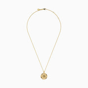 The D'Oro 14K Yellow Gold Diamond Compass Coin Pendant features a round medallion with a compass-inspired design, accented by a diamond at the center and suspended from a delicate yellow gold chain.
