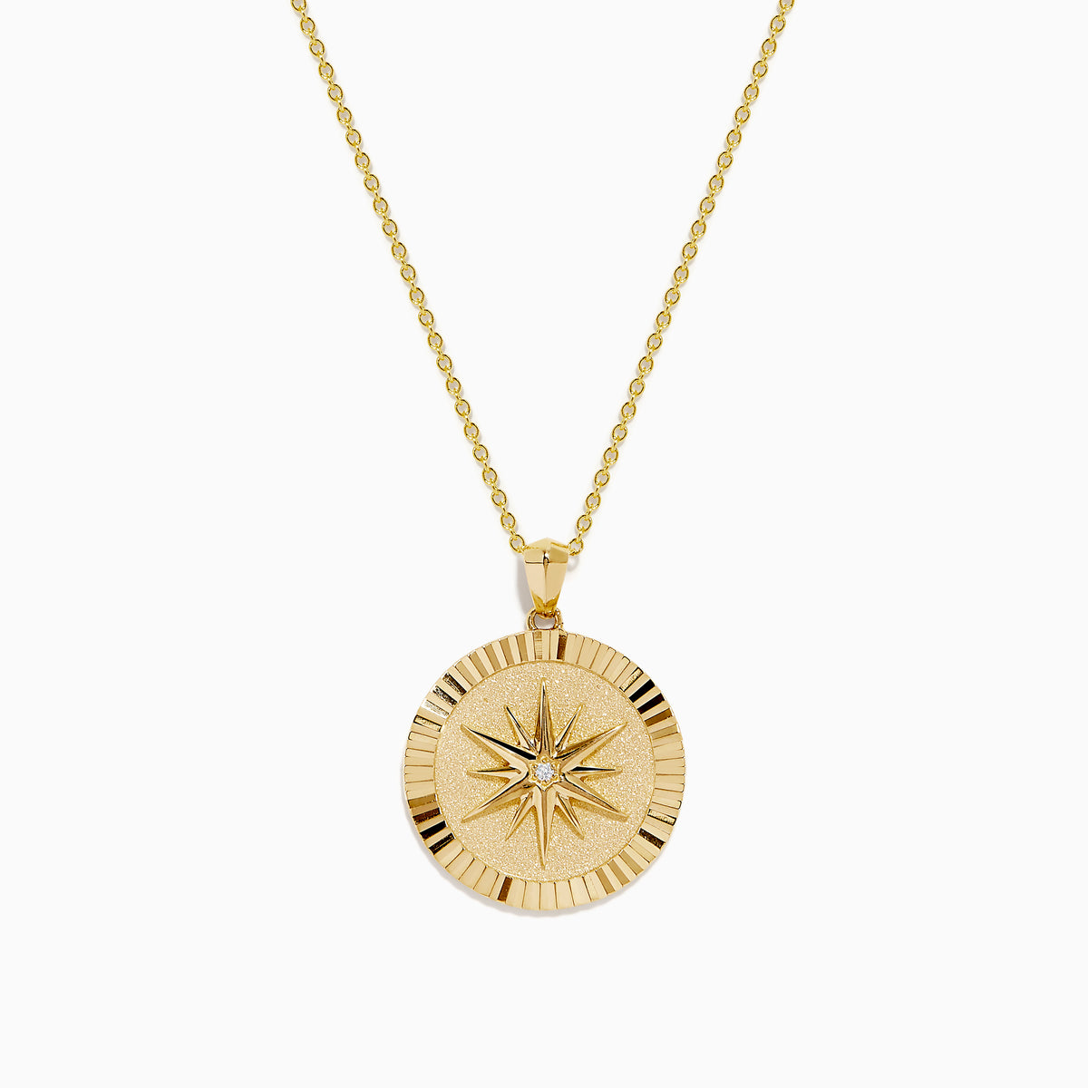 The D'Oro 14K Yellow Gold Diamond Compass Coin Pendant features a round medallion with a compass-inspired design, accented by a diamond at the center and suspended from a delicate yellow gold chain.