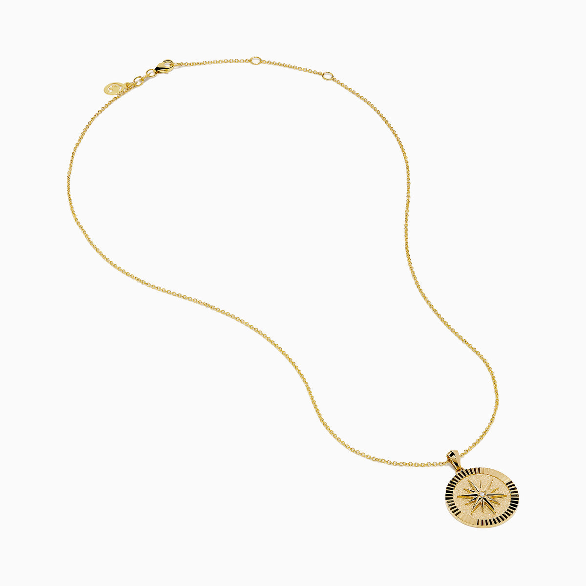 The D'Oro 14K Yellow Gold Diamond Compass Coin Pendant features a round medallion with a compass-inspired design, accented by a diamond at the center and suspended from a delicate yellow gold chain.