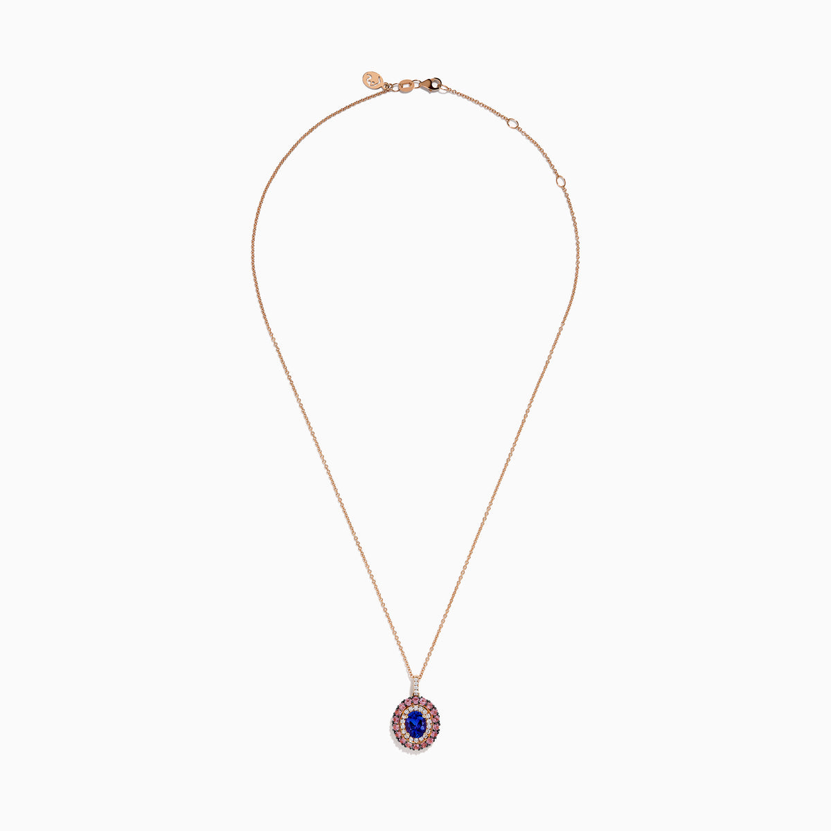 The 14K Rose Gold Pink Sapphire, Tanzanite, and Diamond Double Halo Pendant features an oval-shaped blue gemstone surrounded by pink sapphires, tanzanite, and diamonds on a delicate 14K rose gold chain attached at the top.