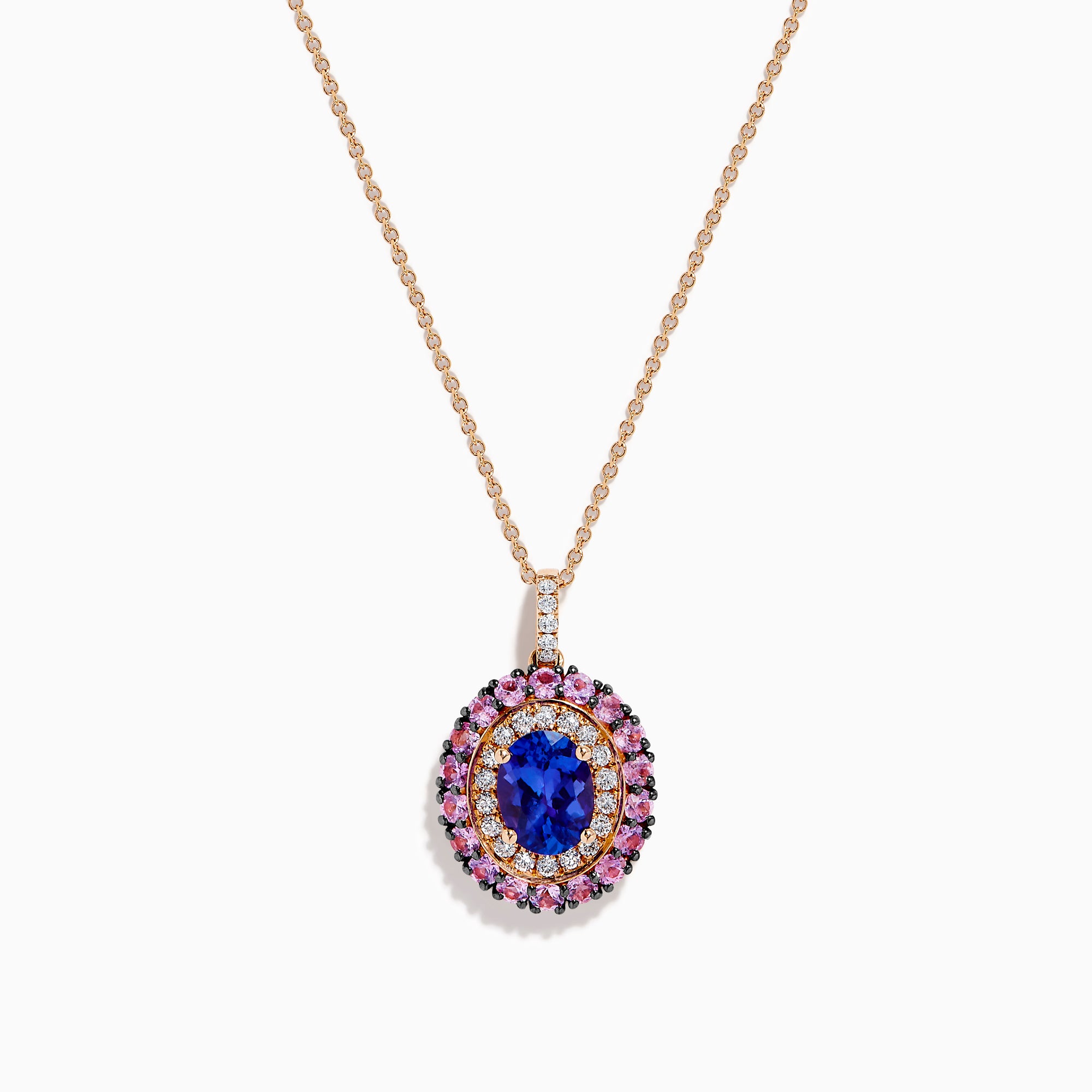 The 14K Rose Gold Pink Sapphire, Tanzanite, and Diamond Double Halo Pendant features an oval-shaped blue gemstone surrounded by pink sapphires, tanzanite, and diamonds on a delicate 14K rose gold chain attached at the top.