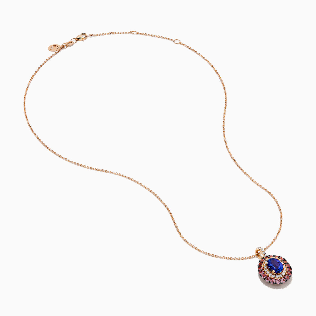 The 14K Rose Gold Pink Sapphire, Tanzanite, and Diamond Double Halo Pendant features an oval-shaped blue gemstone surrounded by pink sapphires, tanzanite, and diamonds on a delicate 14K rose gold chain attached at the top.