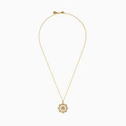 The 14K Yellow Gold Diamond Ship's Wheel Pendant features a ship’s wheel design, accented with sparkling diamonds set symmetrically along the spokes.