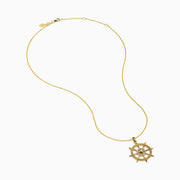 The 14K Yellow Gold Diamond Ship's Wheel Pendant features a ship’s wheel design, accented with sparkling diamonds set symmetrically along the spokes.