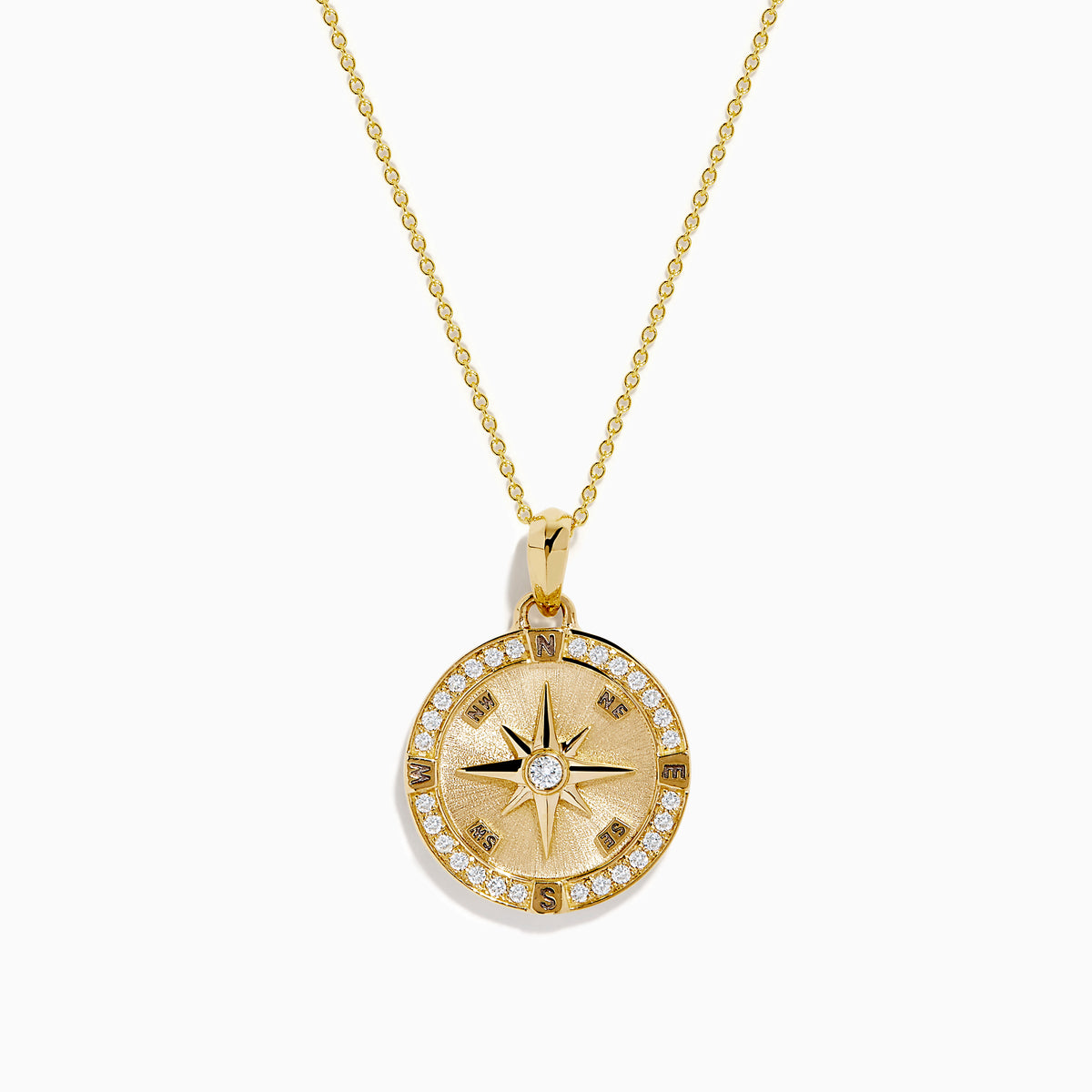 The 14K Yellow Gold Diamond Compass Rose Medallion Pendant features a round diamond compass design with a central gemstone and sparkling border, elegantly suspended from a delicate gold chain.