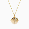 The 14K Yellow Gold Diamond Scallop Shell and Starfish Duo Pendant features a scallop shell and diamond-studded starfish on a fine gold chain, displayed against a white background.