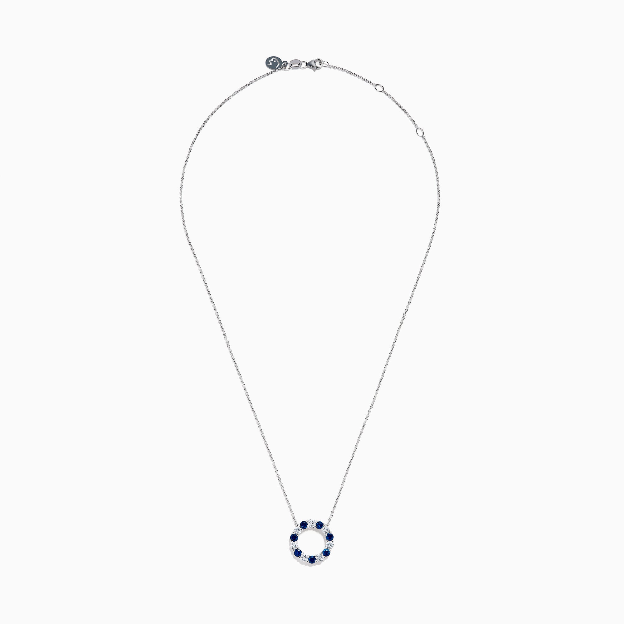 The Royale Bleu 14K white gold necklace features a circular eternity pendant with alternating blue and white sapphires, shown on a white background.