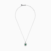 The 14K White Gold Emerald and White Sapphire Halo Pendant features an oval emerald accented by a double halo of sparkling white sapphires.