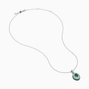 The 14K White Gold Emerald and White Sapphire Halo Pendant features an oval emerald accented by a double halo of sparkling white sapphires.