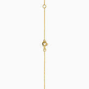 14K Yellow Gold Ruby, Diamond, and Enamel Pendant featuring a delicate gold chain, round pendant with blue and green enamel, a central ruby teardrop, and a sunburst of small clear stones.