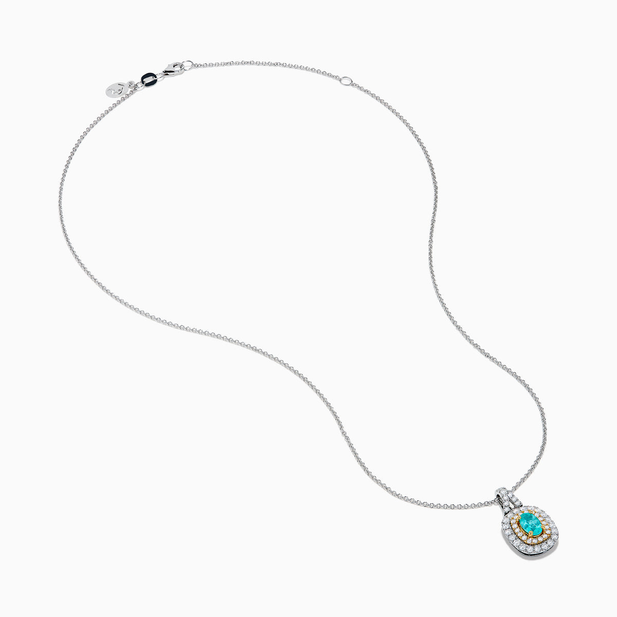The 18K Two Tone Gold Paraiba and Diamond Double Halo Pendant showcases an oval Paraiba centerpiece, surrounded by a halo of yellow stones and a second halo of sparkling diamonds.