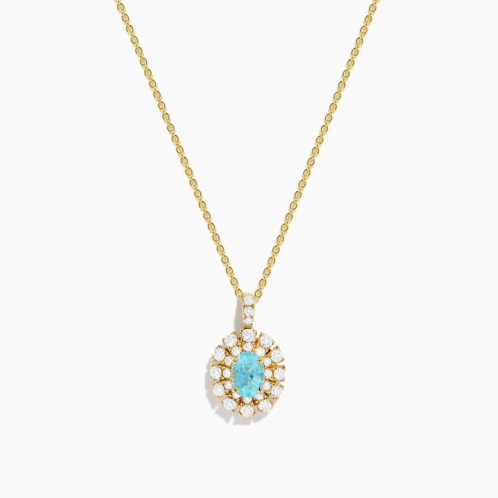 The 18K Yellow Gold Paraiba and Diamond Pendant features an oval turquoise Paraiba gemstone accented by a halo of sparkling diamonds, showcased against a white background.