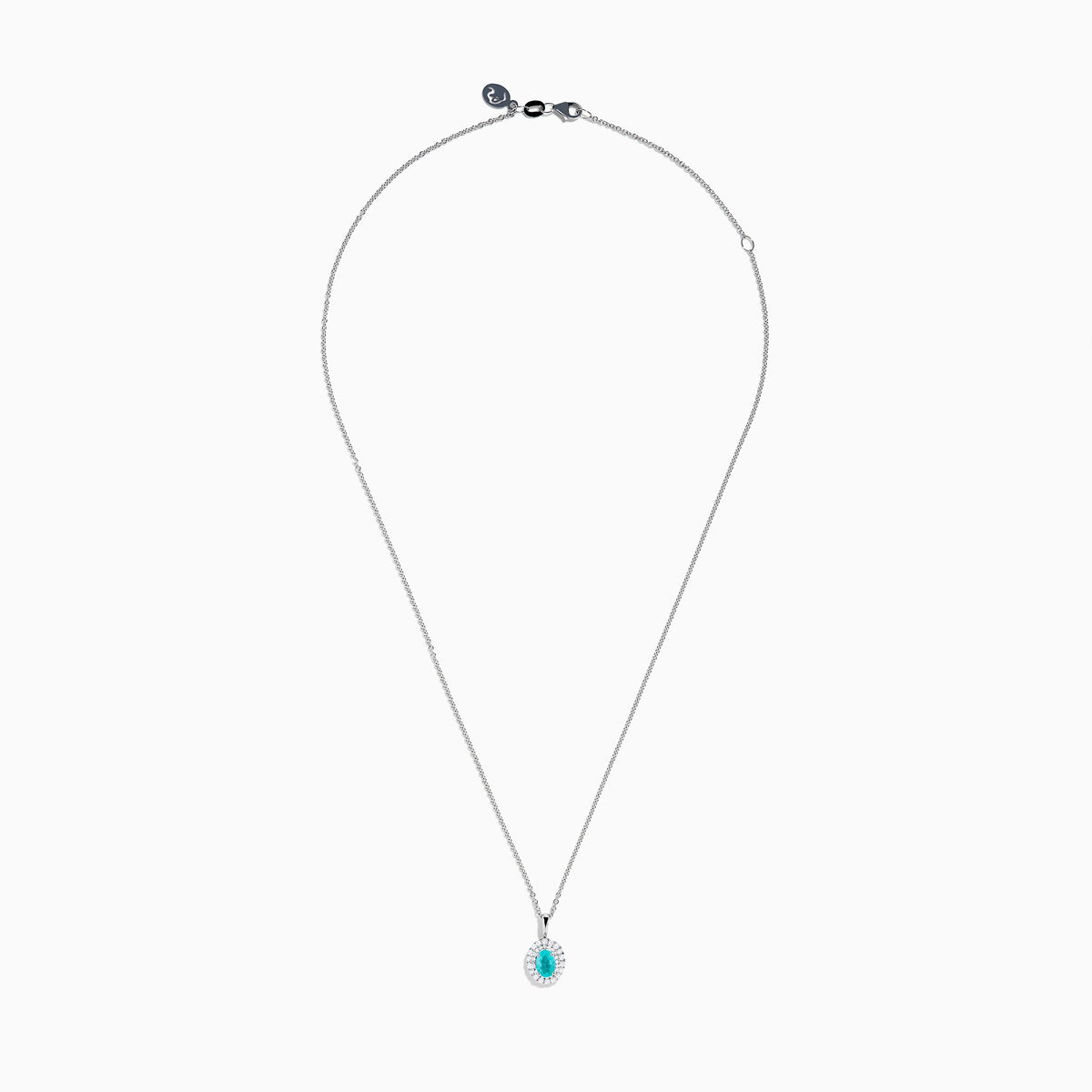 An 18K White Gold Paraiba and Diamond Pendant with an oval Paraiba gemstone and a halo of diamonds hangs from a delicate chain, shown against a plain white background.
