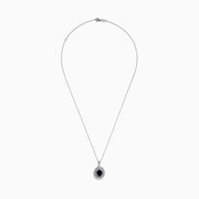 The Royal Bleu 14K White Gold Sapphire & Diamond Halo Pendant features a vibrant sapphire framed by two rows of sparkling white diamonds, all set in a chain necklace against a plain white background.