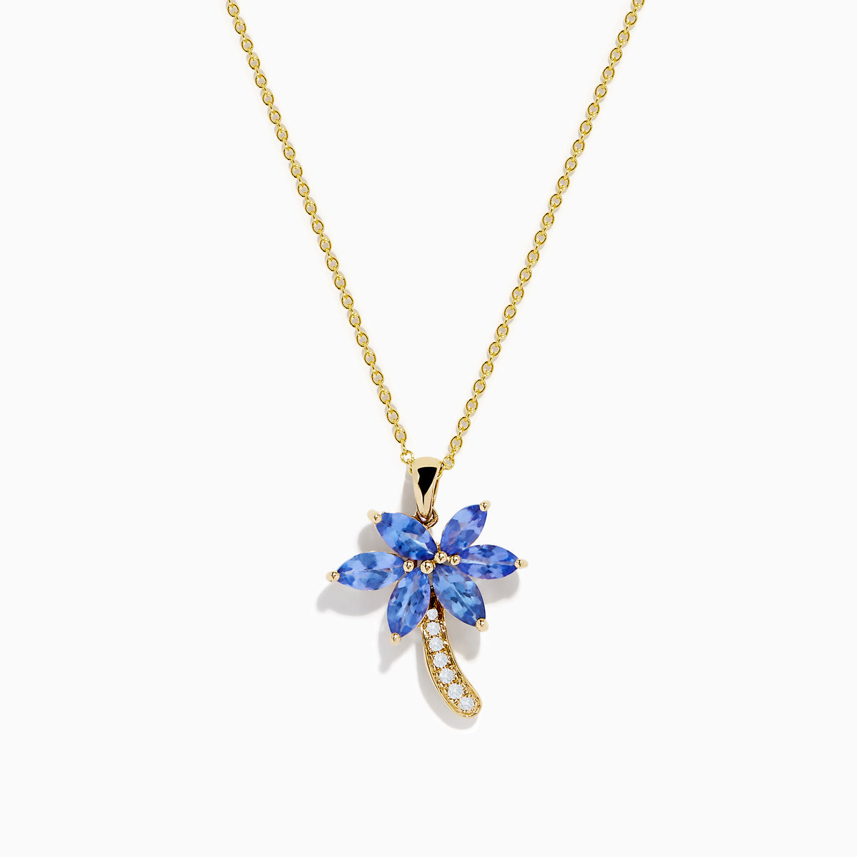 The Nahla Siri 14K Yellow Gold Tanzanite and Diamond Palm Tree Pendant features marquise-cut blue tanzanite leaves and sparkling diamonds accenting the curved trunk for added brilliance.