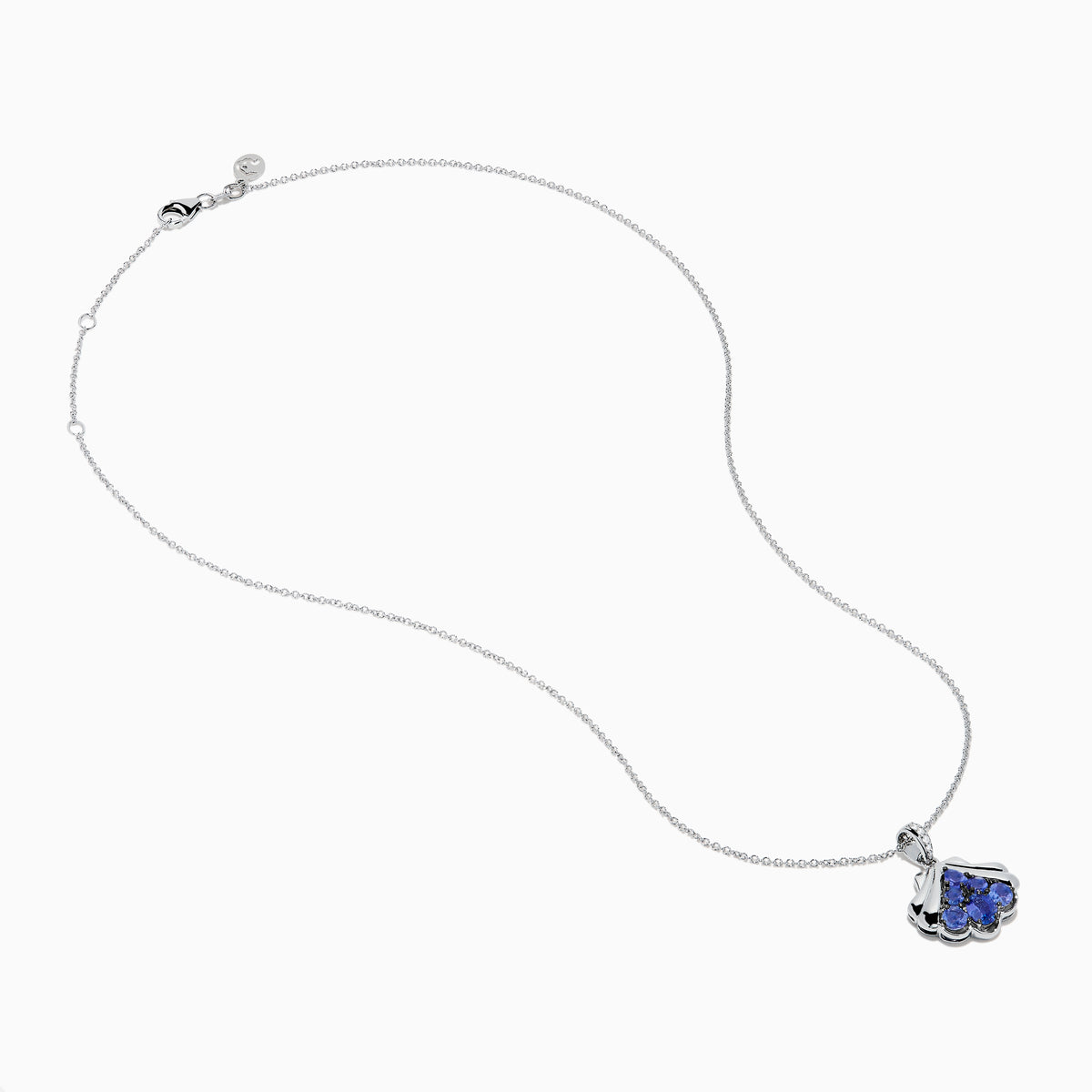 The Seaside 925 Silver Tanzanite and Diamond Seashell Pendant features five round blue tanzanite gemstones in a teardrop design, accented by a row of sparkling diamonds on the pendant’s bail.
