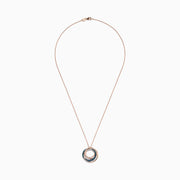 The 14K Rose Gold Blue and White Diamonds Circle Pendant showcases three interlocking circles, with two adorned by sparkling blue and white diamonds, beautifully presented against a white background.