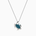 The Seaside 14K White Gold Blue Diamond Crab Pendant features sparkling blue diamonds on its shell, crafted in elegant white gold and shown against a plain white background.