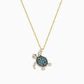 The Seaside 14K Yellow Gold Blue and White Diamond Turtle Pendant features sparkling blue and white diamonds on the shell, head, and flippers of a turtle, set on a gold chain against a plain white background.