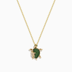 The Seaside 14K Yellow Gold Tsavorite and Diamond Turtle Pendant showcases a large turtle with a tsavorite shell and a smaller diamond-encrusted turtle, both suspended from a delicate gold chain.