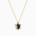Seaside 14K Yellow Gold Blue Sapphire and Diamond Turtle Pendant showcased on a white background, featuring a turtle with a sapphire-studded shell and gold accents on its head, legs, and flipper.